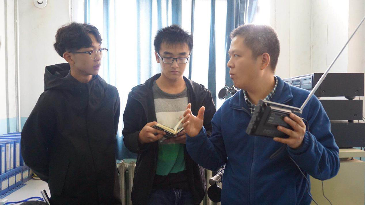 郑州人民广播电台技术人员朱祖来(右)与太阳成集团tyc9728广播站负责人在调试信号